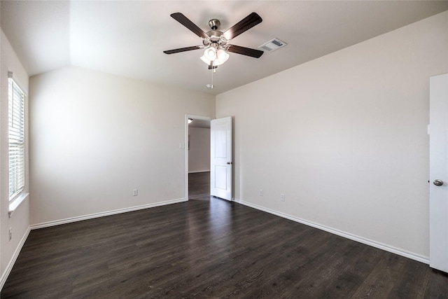 empty room with vaulted ceiling, dark hardwood / wood-style floors, and ceiling fan