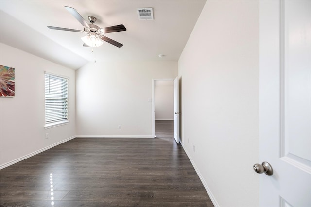 spare room with lofted ceiling, dark wood-type flooring, and ceiling fan