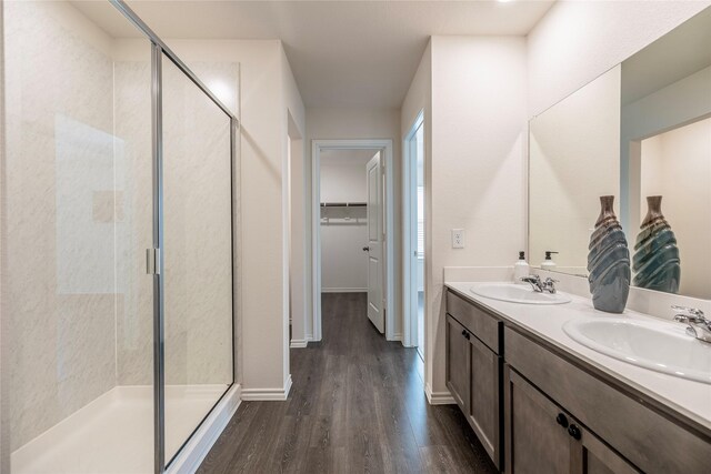 bathroom with vanity, an enclosed shower, and hardwood / wood-style floors