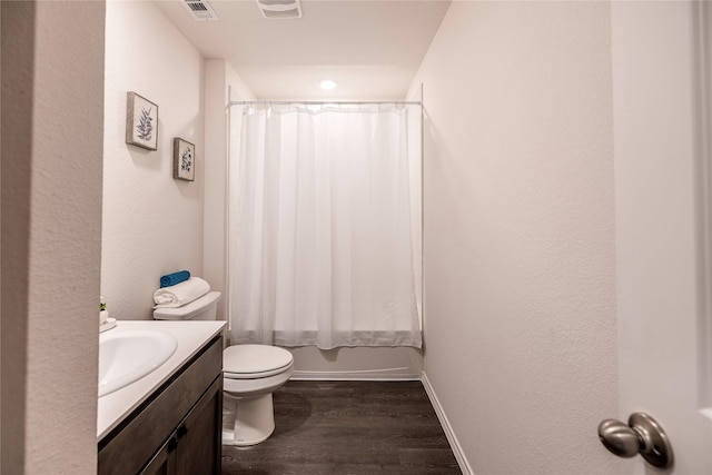 full bathroom with wood-type flooring, shower / tub combo with curtain, vanity, and toilet