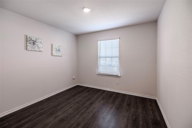 unfurnished room featuring dark hardwood / wood-style floors