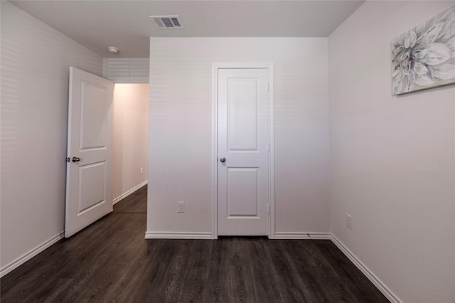 unfurnished bedroom featuring dark wood-type flooring