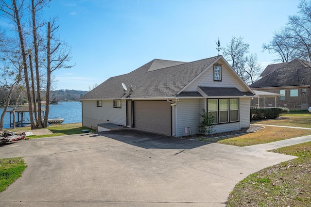 view of front of property featuring a garage and a water view