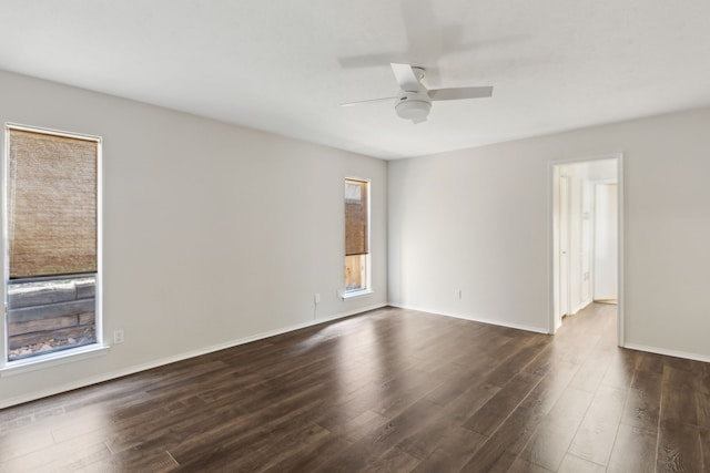 empty room with dark hardwood / wood-style flooring and ceiling fan