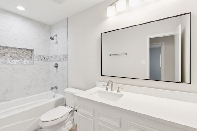 full bathroom with tiled shower / bath, vanity, and toilet