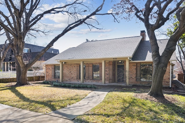 view of front of home with a front yard and covered porch