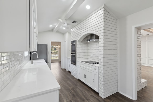 kitchen with dark hardwood / wood-style floors, lofted ceiling with beams, white cabinetry, sink, and black electric cooktop