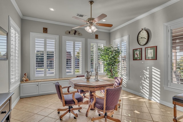 dining space with light tile patterned floors, a wealth of natural light, and ornamental molding