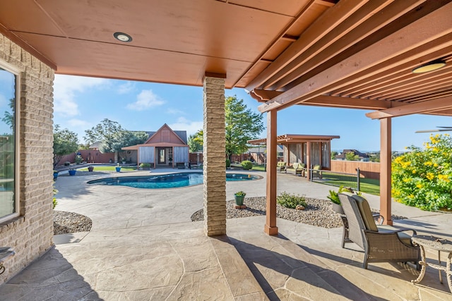 view of patio / terrace with an outdoor structure and a fenced in pool