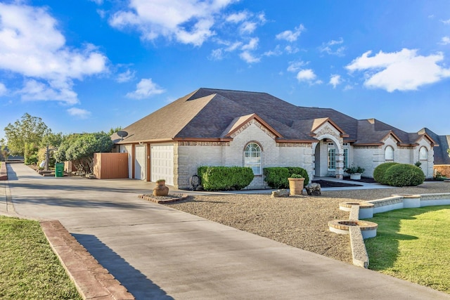 french country home featuring a garage