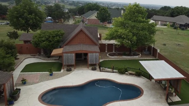 view of swimming pool with a lawn and a patio