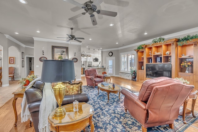 living room with crown molding and light wood-type flooring