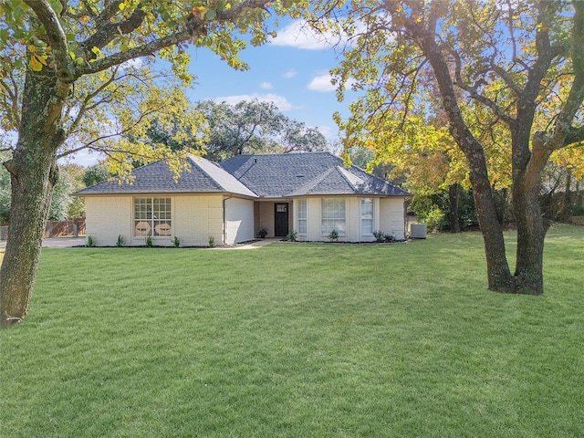 ranch-style home featuring a front yard and a garage