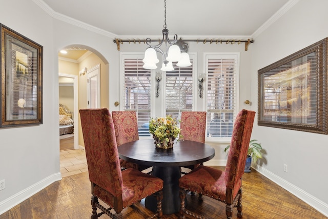 dining space featuring crown molding, dark hardwood / wood-style floors, a chandelier, and a wealth of natural light