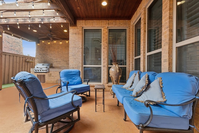 view of patio / terrace with area for grilling, ceiling fan, and a pergola