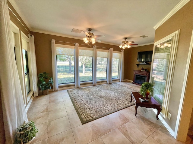 living room with crown molding, ceiling fan, and light tile patterned floors