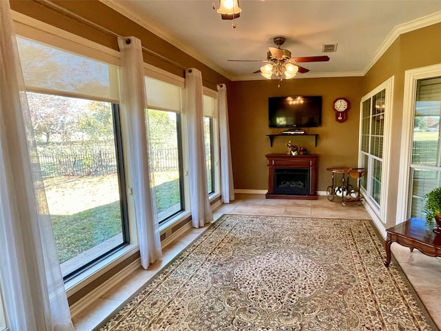 entryway with light tile patterned floors, crown molding, and ceiling fan