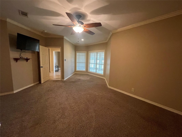 unfurnished room featuring dark colored carpet, ceiling fan, and crown molding