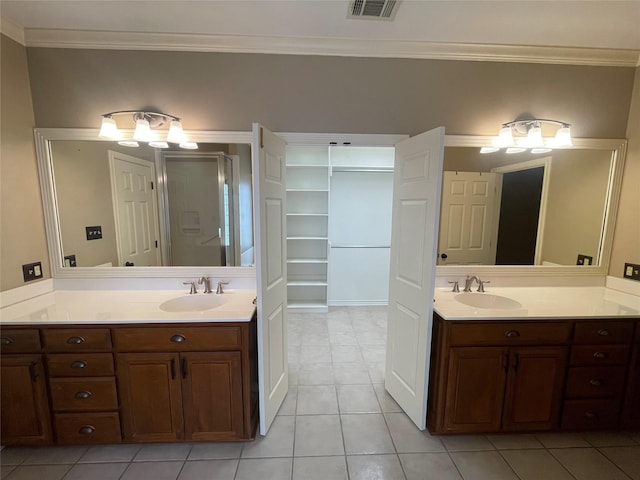 bathroom featuring tile patterned flooring, ornamental molding, and vanity