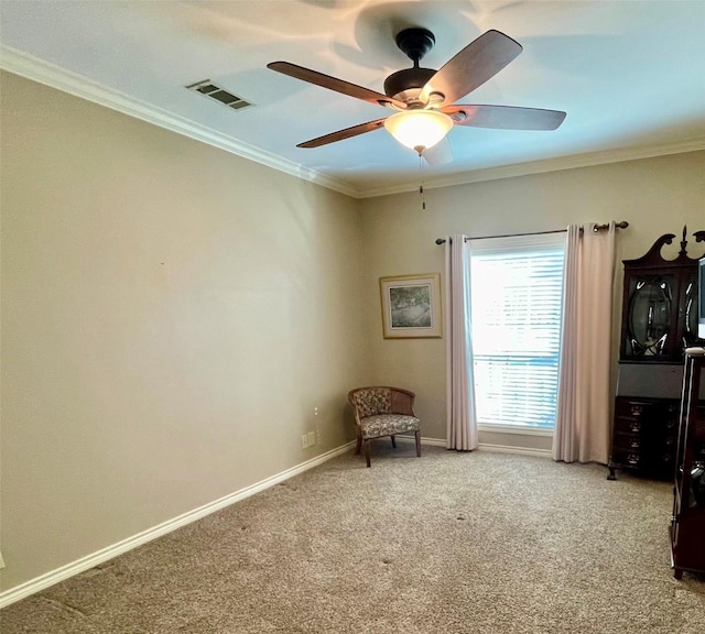 unfurnished room with crown molding, carpet floors, and ceiling fan