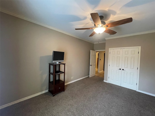 unfurnished bedroom with ornamental molding, dark carpet, and a closet