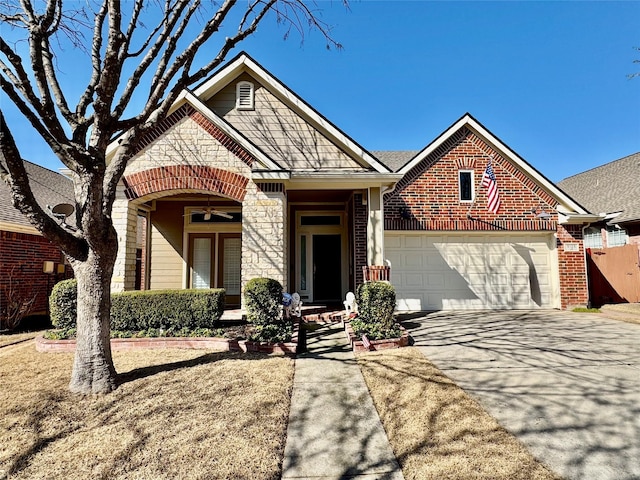 view of front of house featuring stone siding, concrete driveway, a garage, brick siding, and ceiling fan