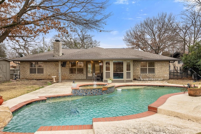 view of swimming pool featuring an in ground hot tub and a patio