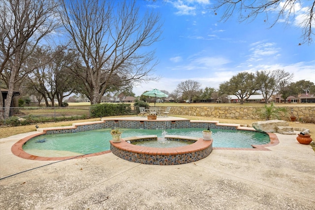 view of swimming pool featuring a patio, pool water feature, and an in ground hot tub