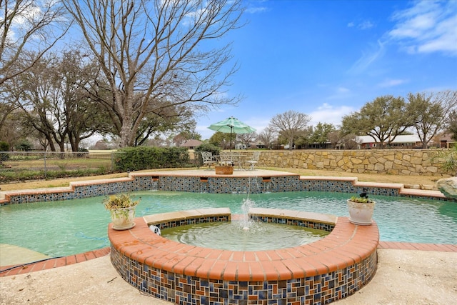 view of pool featuring an in ground hot tub