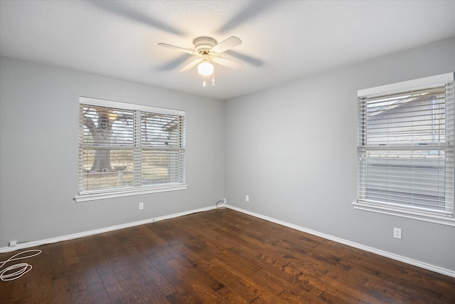 unfurnished room featuring dark wood-type flooring and ceiling fan