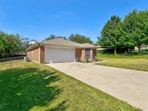 single story home featuring a garage and a front yard