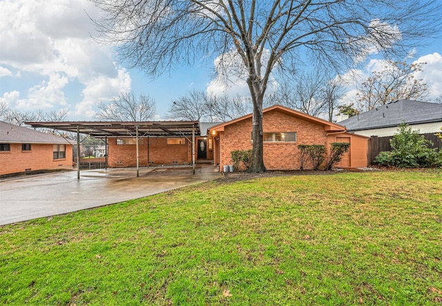 back of property featuring a carport and a yard