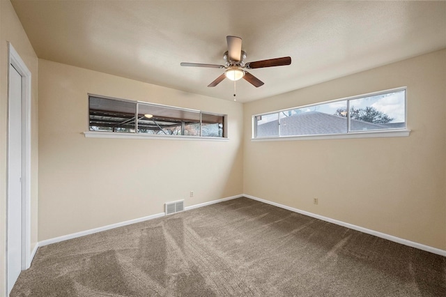 carpeted empty room featuring ceiling fan