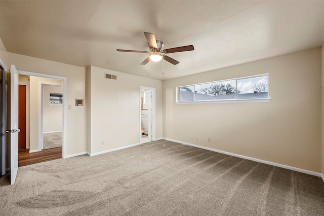 unfurnished bedroom featuring ensuite bath, carpet floors, and ceiling fan