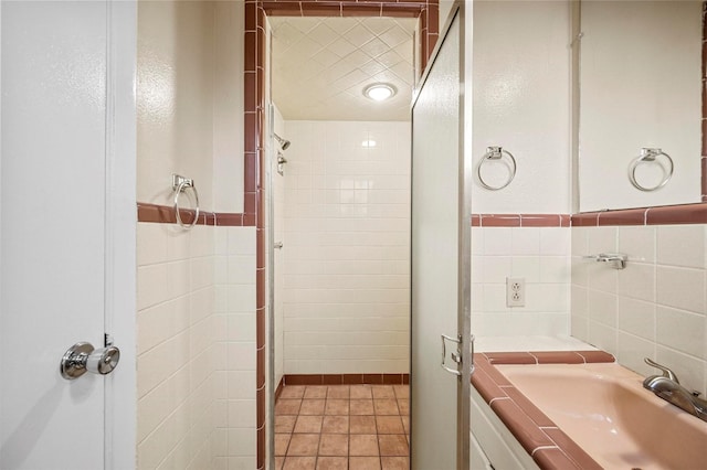 bathroom with tile patterned floors, tile walls, and vanity