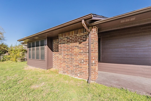 view of side of home with a yard