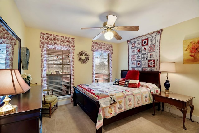 bedroom with light colored carpet and ceiling fan