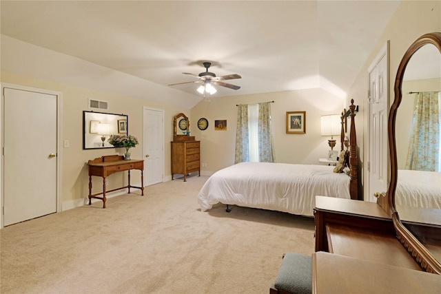 bedroom with lofted ceiling, light colored carpet, and ceiling fan