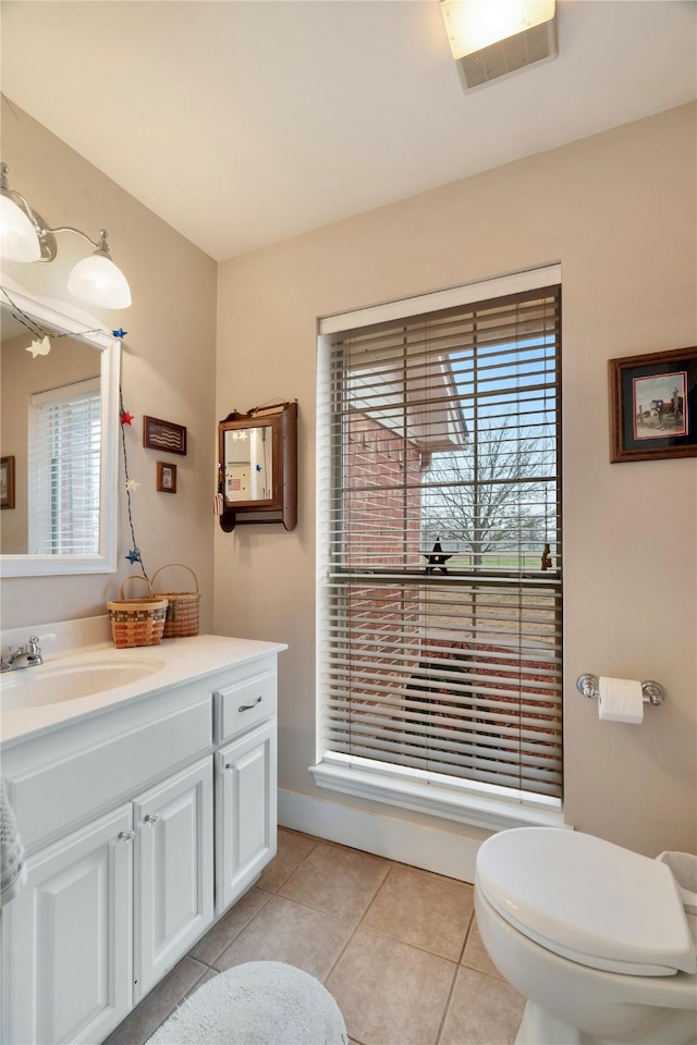 bathroom with vanity, tile patterned floors, and toilet