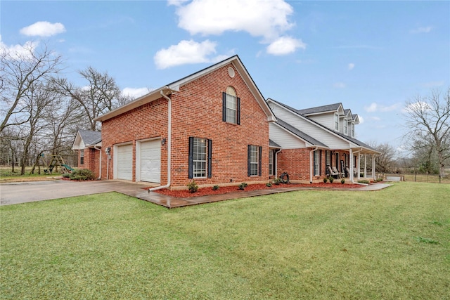 view of side of home with aphalt driveway, brick siding, a lawn, and a garage