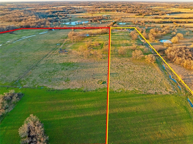 drone / aerial view featuring a rural view and a water view