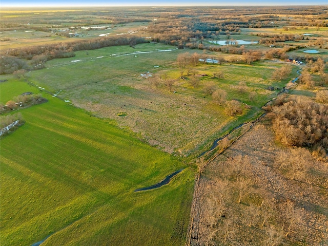 drone / aerial view featuring a water view and a rural view