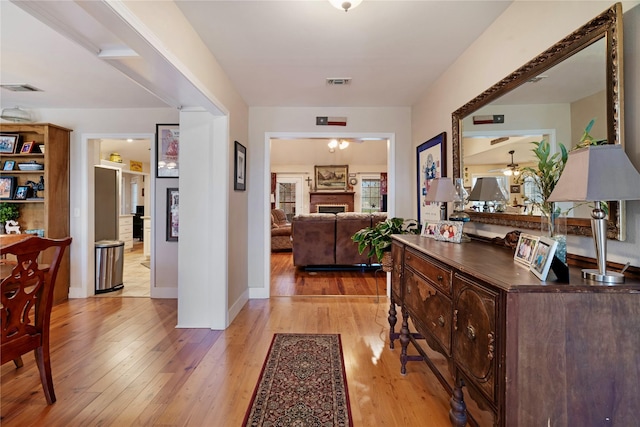 corridor with light hardwood / wood-style floors