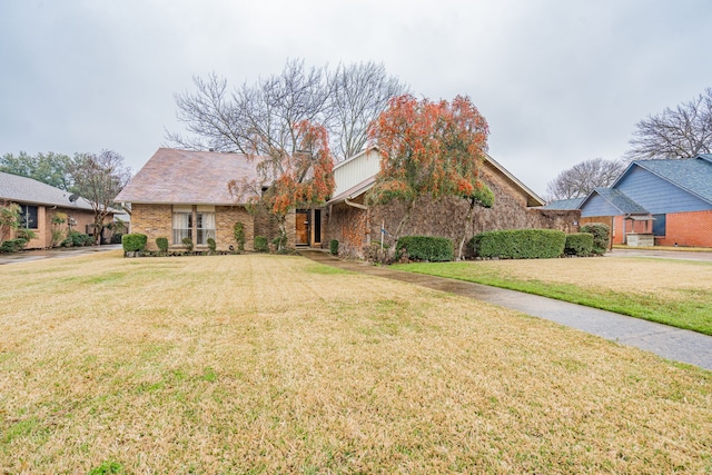 view of front facade with a front lawn and brick siding