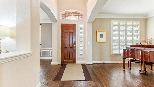 foyer entrance featuring ornamental molding and dark hardwood / wood-style floors