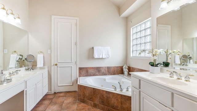 bathroom with vanity, a relaxing tiled tub, and tile patterned floors