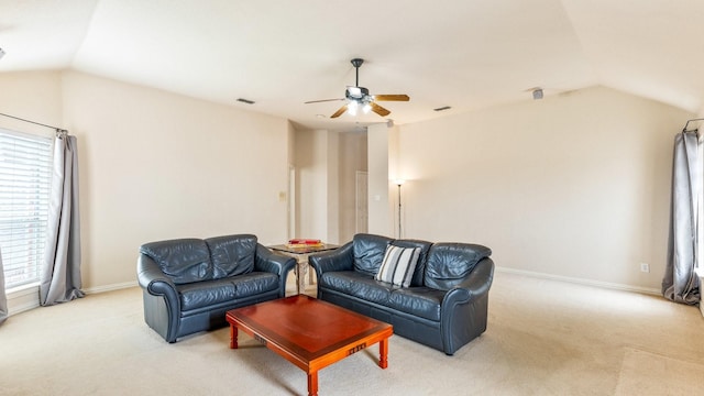 carpeted living room with ceiling fan and lofted ceiling