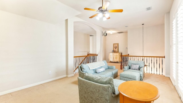 sitting room featuring light carpet and ceiling fan