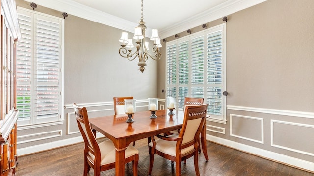 dining area with ornamental molding, a notable chandelier, and dark hardwood / wood-style flooring