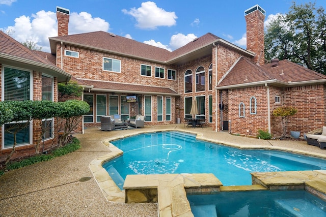 rear view of property with a fenced in pool, a patio area, and outdoor lounge area